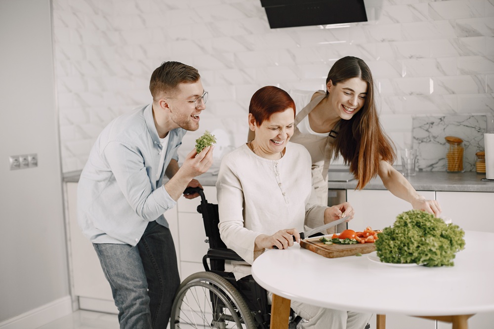Mature disabled woman cutting vegetables in the kitchen